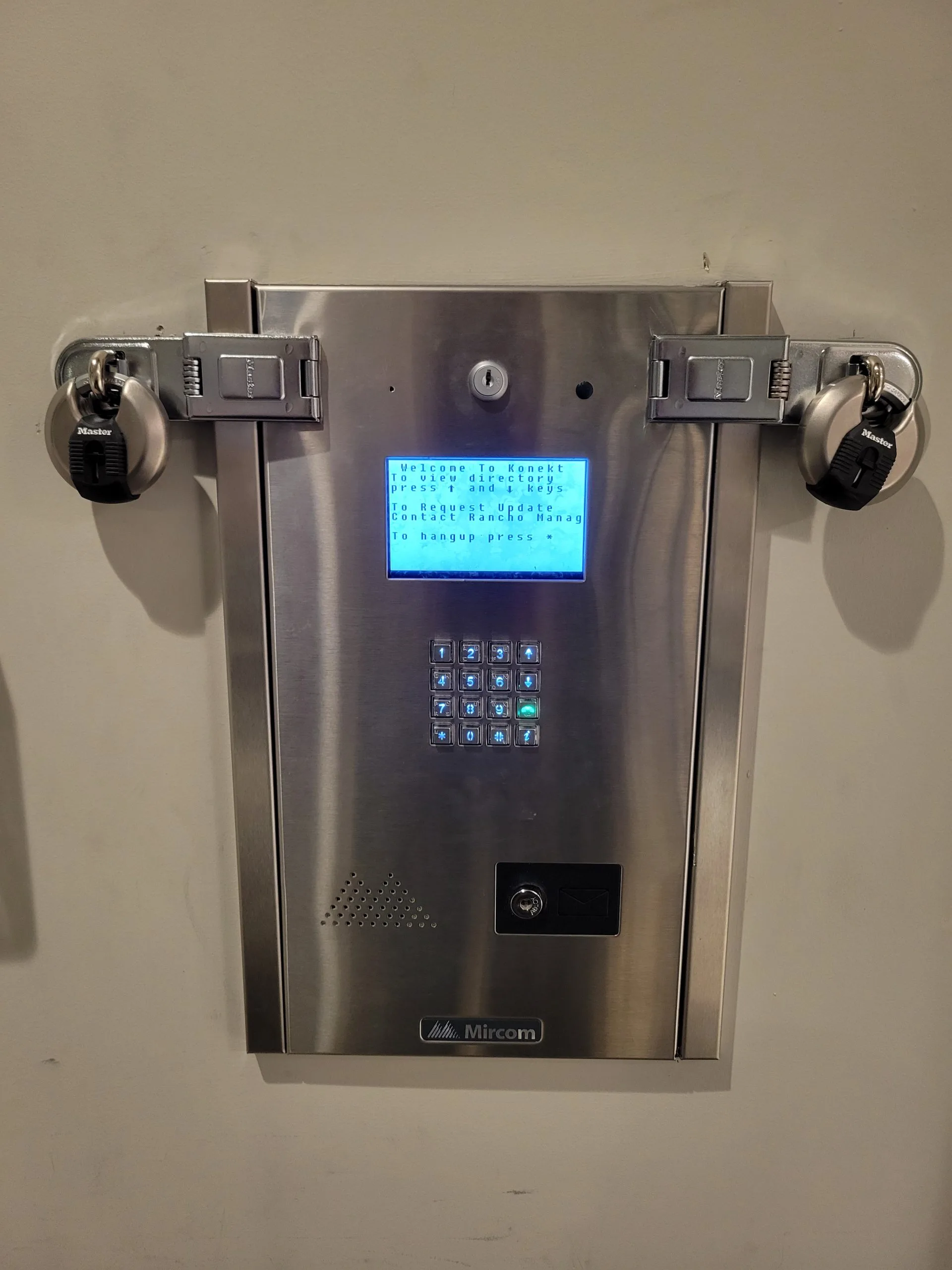 Video voice intercom entry systems installation features a metallic unit with a digital display on a wall